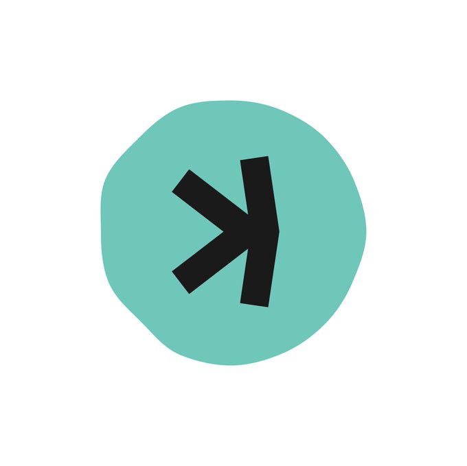 A simple graphic features a black stylized arrow or fish-like symbol centered on a teal, irregularly shaped blob against a white background.