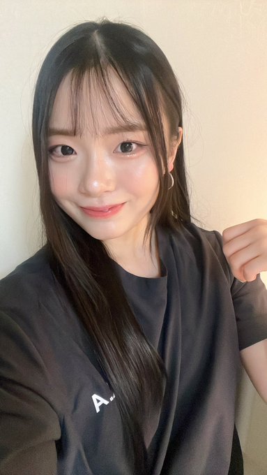 The image features a young woman with long hair, wearing a black shirt or sweater. She has her arm raised above her head while looking at the camera. The background of the photo appears to be a wall, which could potentially be part of an advertisement for a product or service related to Web3 technology.