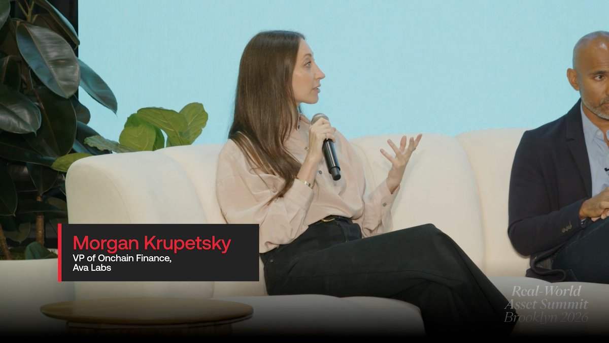 A woman identified as 'Morgan Krupetsky, VP of Onchain Finance, Ava Labs' speaks into a microphone while seated on a white couch at the 'Real-World Asset Summit Brooklyn 2026' panel discussion.