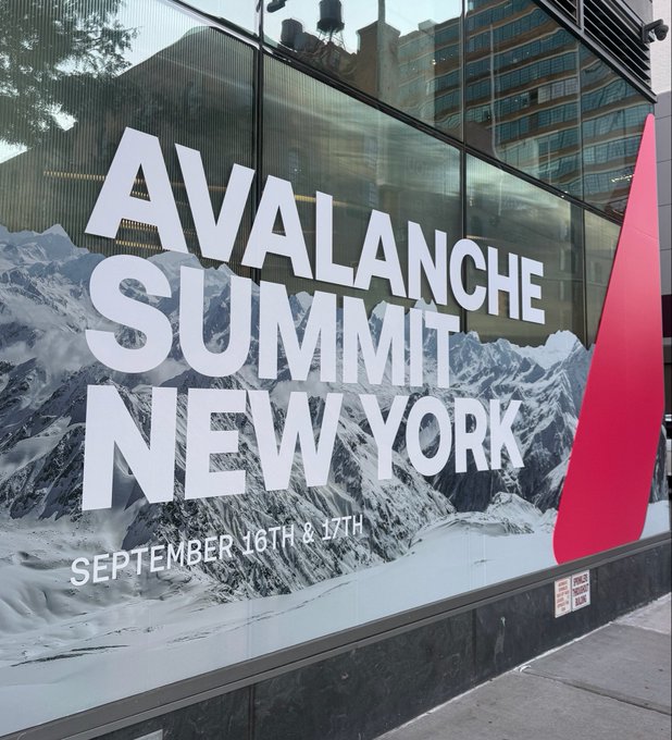 A large banner on a glass building exterior advertises "AVALANCHE SUMMIT NEW YORK" taking place September 16th & 17th, set against an icy mountain backdrop, marking the eve of the conference as anticipated in the accompanying post.