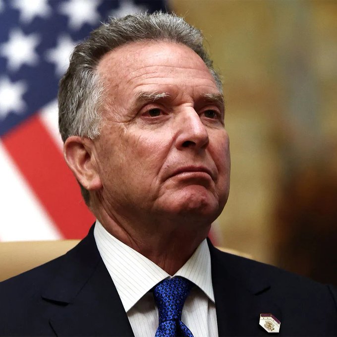 Steve Witkoff, President Trump's special envoy, is pictured wearing a dark suit, white striped shirt, and patterned blue tie, with an American flag visible behind him.

The image shows Steve Witkoff, identified in the accompanying post as Trump's special envoy who reportedly earned $107 million from Trump-backed World Liberty Financial in 2025 according to Bloomberg.