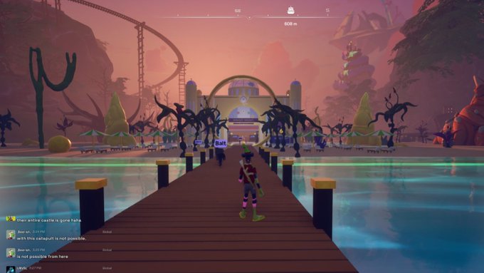 A video game screenshot shows a character standing on a wooden pier leading toward a colorful building entrance, with chat messages visible in the bottom left corner.