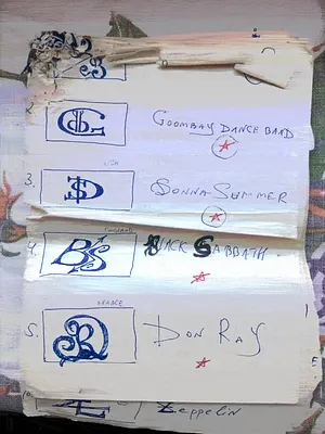 A handwritten list with blue ink monogram logos next to names like 'Goombay Dance Band', 'Sonia Summer', 'Nick Sabath', and 'Don Ray', each marked with a red star.