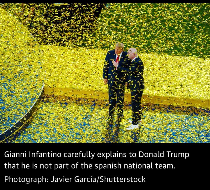 A photograph by Javier García/Shutterstock showing two men standing amid a massive shower of yellow confetti, with a caption reading 'Gianni Infantino carefully explains to Donald Trump that he is not part of the spanish national team.'
