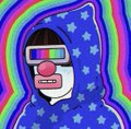 A small cartoonish character with a wide grin wearing 3D glasses, set against a wavy, colorful psychedelic background with stars.