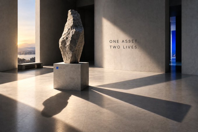 A minimalist gallery space featuring a large rock sculpture on a pedestal labeled 'BASE,' with the text 'ONE ASSET, TWO LIVES.' displayed on the wall.