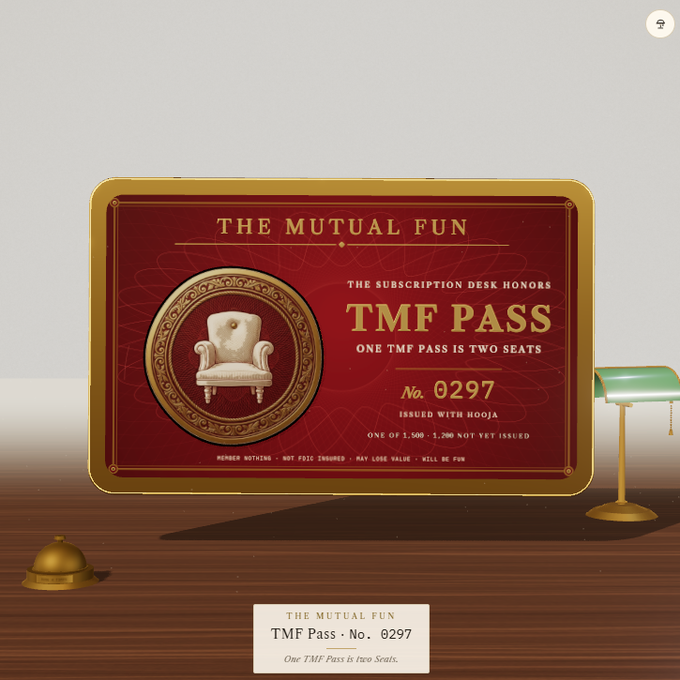 A digital rendering of 'THE MUTUAL FUN' TMF Pass No. 0297, a red and gold ticket stating 'ONE TMF PASS IS TWO SEATS' displayed on a desk with a green lamp.
