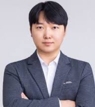 The image features a man dressed in a suit, standing against a plain white background. He has his arms crossed confidently over his chest, with an intense gaze directed towards the camera. The caption below the photo reads: "World’s highest-IQ holder YoungHoon Kim predicts $XRP could reach between $5 and 
$10 this market cycle." This post seems to be related to cryptocurrency and its potential impact on the economy, as suggested by the quote provided in the image.