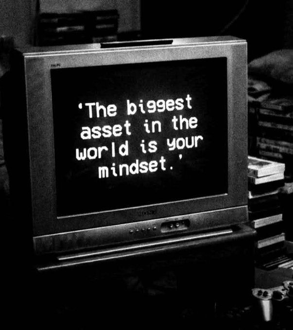 Black and white photo of an old CRT television displaying the motivational quote: 'The biggest asset in the world is your mindset.'
