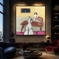 A dimly lit living room featuring a large illuminated pixel art piece on the wall above a coffee table.