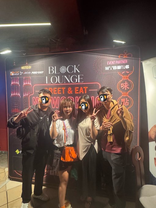 Four people pose for a photo with peace signs in front of a 'BLOCK LOUNGE' event banner that reads 'MEET & EAT - NOW SERVING' and is hosted by 'FOMO CAST' with event partner 'Mr. T'.eyes.