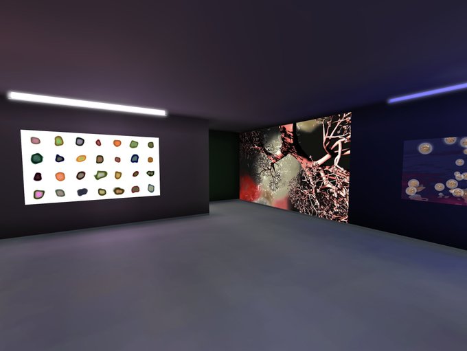 A virtual gallery space displaying three artworks on dark walls: a grid of colorful polished stones, a detailed red and black image resembling intertwined branches or roots, and an abstract blue composition with circular shapes.