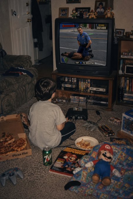 A nostalgic photo of a child playing a console game on a CRT television in a cluttered living room, with a pizza box, soda can, and Nintendo Power magazine scattered on the floor.