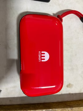 A glossy red power bank branded with the white "KRAKEN" logo rests on a light-colored surface, pictured as the giveaway prize in a promotional post from Kraken, the official cryptocurrency exchange sponsor of the 2026 FIFA World Cup.