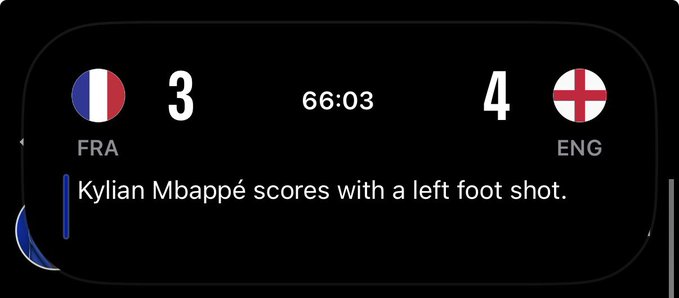 A sports score notification shows France (FRA) trailing England (ENG) 3-4 at 66:03, with an update reading "Kylian Mbappé scores with a left foot shot," suggesting France has cut the deficit to one goal with time remaining in the match.