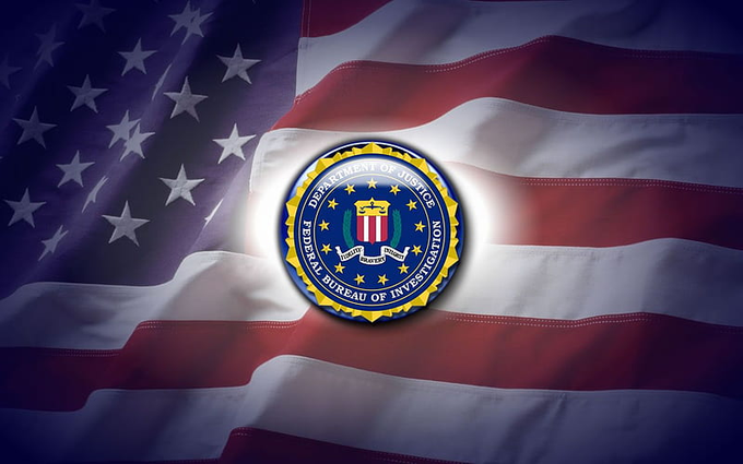 The image features an American flag with the FBI logo located in the center, surrounded by white stars arranged on top and bottom of the blue background. A subtitle below reads "FBI just seized over 127,000 BTC worth more than $9.2 BILLION from what may be the largest crypto fraud empire ever uncovered". This post seems to be a news article or an eye-catching design related to recent events involving the FBI and cryptocurrency theft.