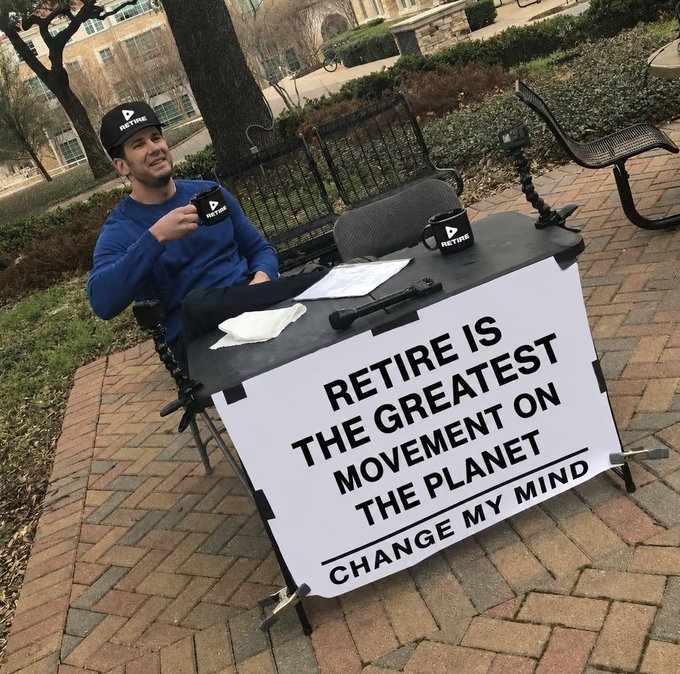 A man wearing a 'RETIRE' cap sits at an outdoor table with a large sign reading 'RETIRE IS THE GREATEST MOVEMENT ON THE PLANET — CHANGE MY MIND'.