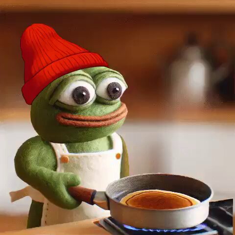 The image features a cartoon frog wearing an apron, standing next to a frying pan filled with pancakes. The frog appears to be cooking breakfast for someone else, possibly a human friend or family member. The caption "GM TODAY IS THE DAY" suggests that this scene is part of a series or collection related to the day being featured in the image.