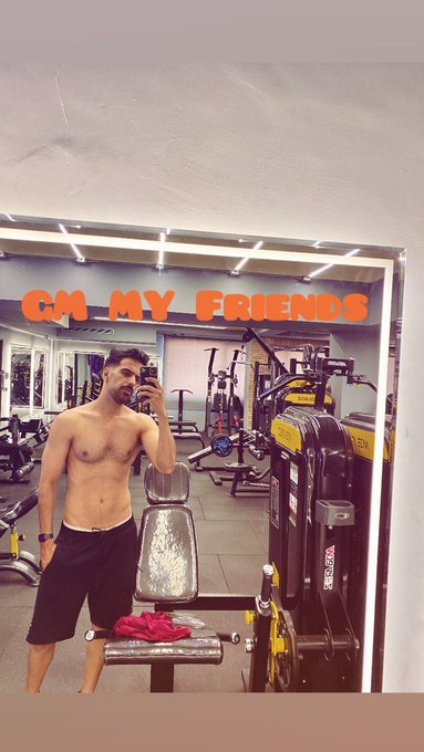 A shirtless man takes a gym selfie in a mirror, with text overlay reading "CH MY FRIENDS" at the top.