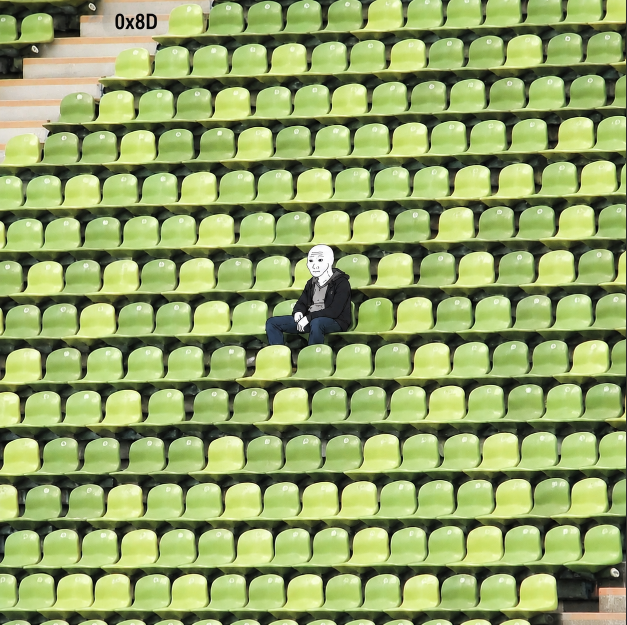 The image shows a person sitting alone in an empty stadium, surrounded by rows of green seats that are currently unoccupied. The person appears to be wearing a black jacket and has a white face painted on their forehead. The scene conveys a sense of emptiness and solitude as the individual sits there with no one else around them.