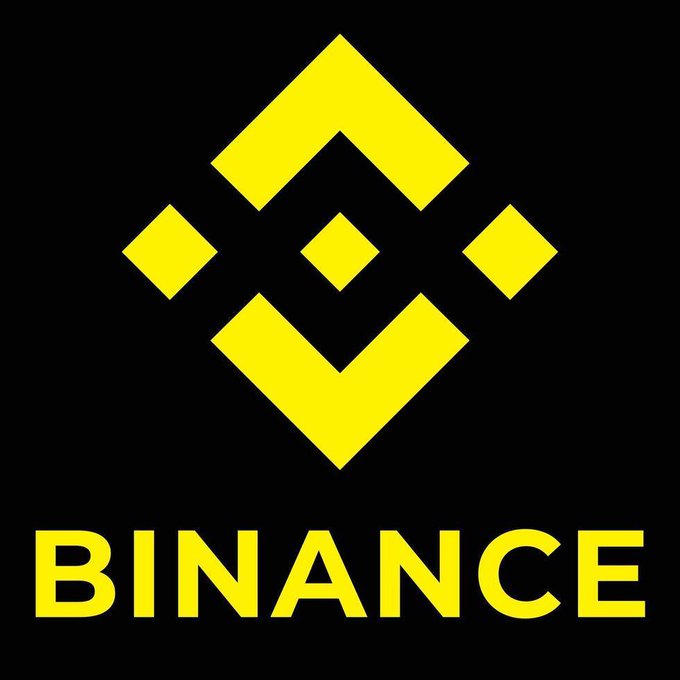 The image shows the Binance cryptocurrency exchange logo—a yellow geometric diamond design with the word "BINANCE" displayed in bold yellow letters beneath it on a black background. The logo directly represents Binance, the platform highlighted in the post as a key player driving the convergence between traditional finance and crypto through stock-linked perpetual contracts.