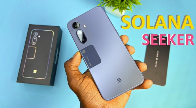 A hand holds a Solana Seeker smartphone displaying its rear camera and crypto wallet features, with the phone's retail box shown beside it, accompanied by the text "SOLANA SEEKER" — illustrating the device tied to the SKR airdrop campaign being promoted in the post.