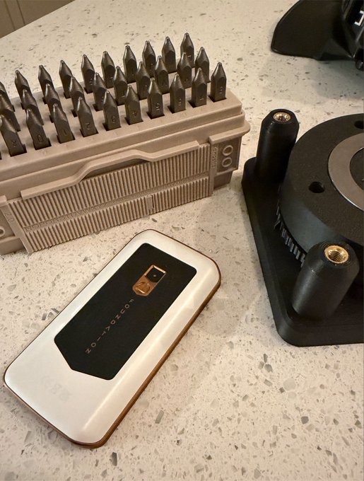 A precision screwdriver bit set, a White-block "ZOLTO" hardware wallet, and a BlockClock device sit on a speckled countertop, illustrating the elaborate self-custody workflow described—stamping seed phrases, segregating KYC and non-KYC UTXOs, and managing the BlockClock display.