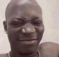 A man with a deeply strained, squinting expression appears to be struggling with frustration, humorously illustrating the exasperation of trying to complete a simple transaction on the Phantom wallet as described in the post. His wincing face captures the relatable Web3 struggle of being unable to buy food due to network issues.