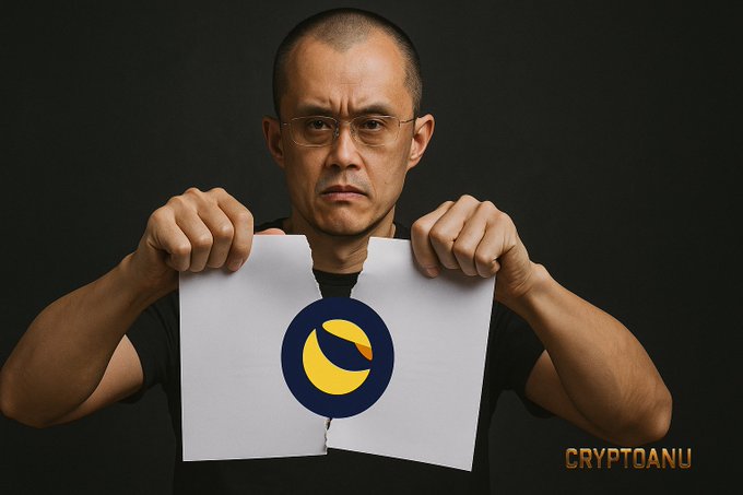 A man intensely rips a white paper in half, revealing a yellow crescent moon logo (Luna Classic symbol) underneath, with "CRYPTOANU" watermarked in the corner—visually representing the post's theme that LUNC and USTC survived the "ripping apart" of the Terra collapse and remain alive.
