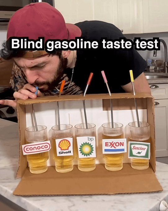 A man in a red cap doing a "Blind gasoline taste test" with cups labeled Conoco, Shell, bp, Exxon, and Sinclair.