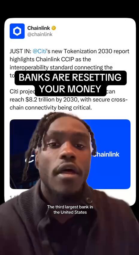 In the image, a man with dreadlocks is speaking into a microphone or camera while holding up a sign. The text displayed on the screen reads "Just In: CCIP's new tokenization report as the interoperability standard connecting the banks." This suggests that Chainlink has released a report about the future of tokenization in banking and how it can be used to connect banks more efficiently. The man with dreadlocks is likely promoting this report or discussing its implications for the financial industry.