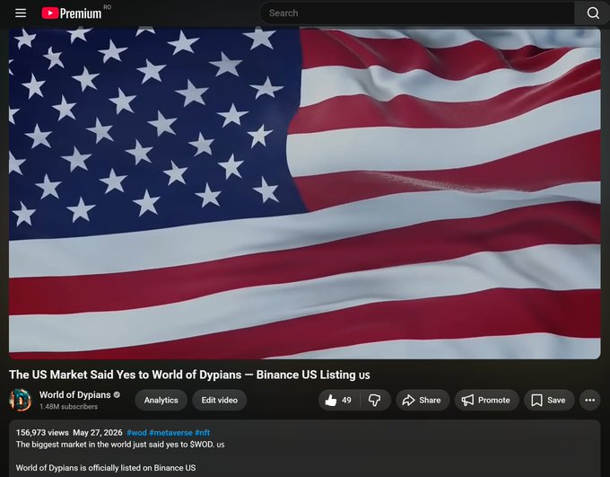 The image features a large American flag with red, white, and blue stripes, fluttering in the wind. The text displayed on the screen reads "The US Market Said Yes to World of Dypians - Binance US Listing us". This suggests that there is a market for trading cryptocurrencies like Bitcoin, which has been gaining popularity worldwide.