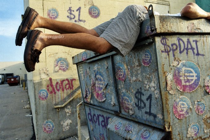A person wearing striped shorts and brown loafers is sprawled face-down across a large metal dumpster labeled "SpDAI" and "$1," with circular stickers featuring a stylized "E" symbol plastered across the weathered surface. The image humorously visualizes the "dumpster diving for $pDAI" line from the post, poking fun at the narrator's self-deprecating commitment to accumulating the "SpDAI" asset despite others calling it a scam.
