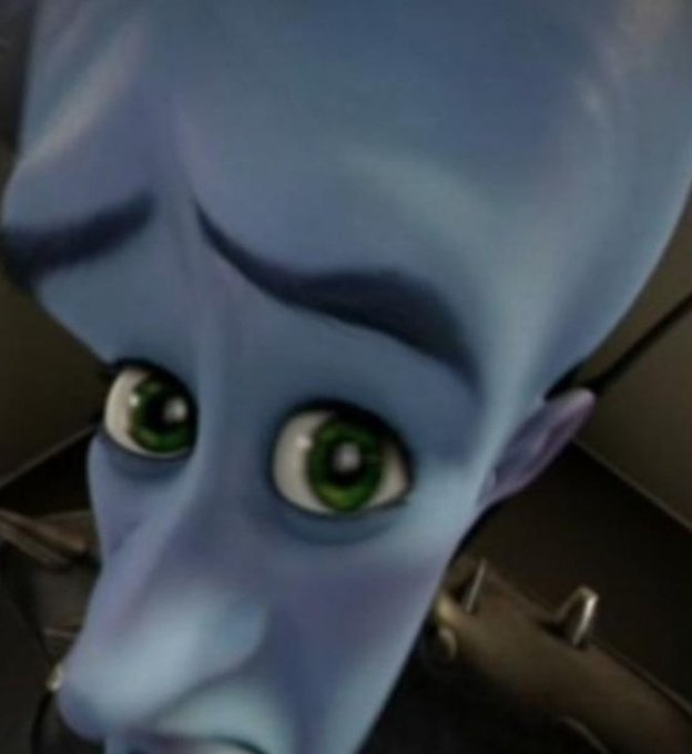 A close-up of the blue alien character from Megamind with large green eyes looking concerned and skeptical, humorously reacting to the question "what's cooking today?" as if judging someone's cooking plans.