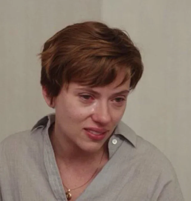 A young person with short brown hair in a gray button-up shirt appears visibly emotional, with tears in their eyes and a distressed expression. The image humorously contrasts with the post's text about "Neo cloud wars," suggesting the person is dramatically mourning the impact of Elon Musk on their crypto mining endeavors.
