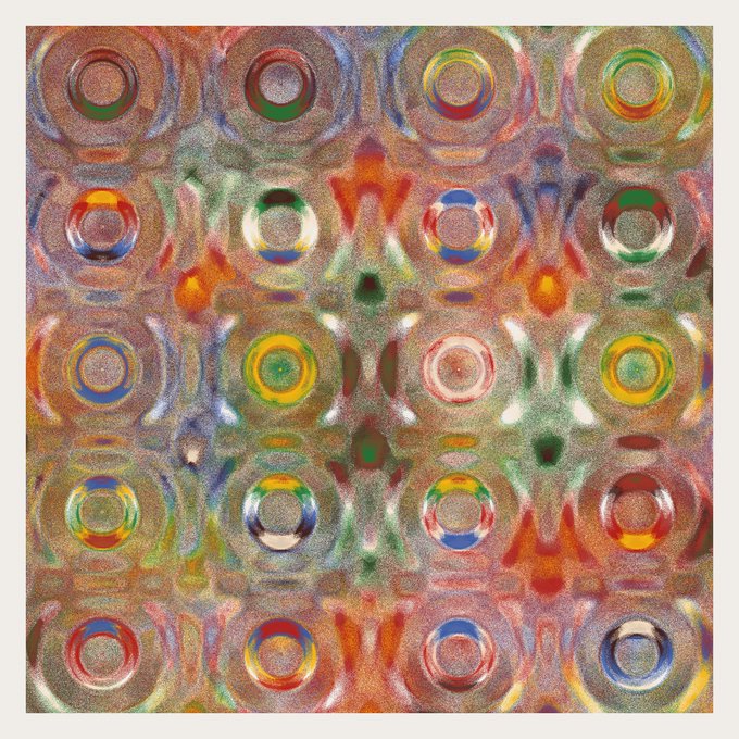 An abstract, colorful image featuring a repeating pattern of multicolored circular rings and shapes.