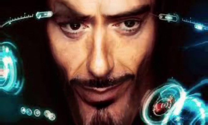 Close-up of Tony Stark (Robert Downey Jr.) as he looks at holographic interfaces in his Iron Man helmet, a scene from a Marvel film.