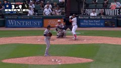 In a Major League Baseball game, a pitcher winds up to deliver a pitch while the batter readies at the plate, with a "WINTRUST" advertisement visible on the outfield wall. The caption "The POWA is back!" suggests the batter is likely renowned for powerful hitting, hinting at a moment poised for a strong swing.