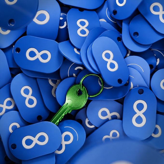 A pile of blue keychains stamped with the Facebook "∞" logo is shown, with a single green key resting on top. The image complements the post by symbolizing those who still hold access to their accounts, with the green key representing successful entry or recovery amid the sea of blue Facebook identifiers.