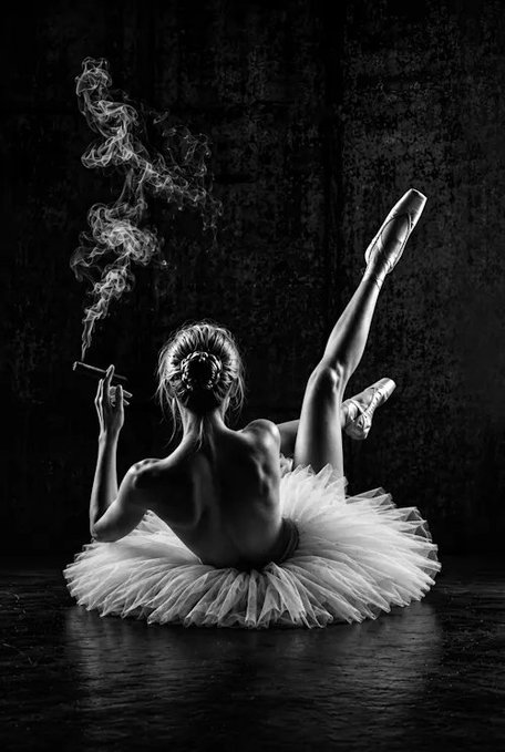 A black-and-white artwork shows a seated ballerina in a white tutu with one leg dramatically raised, holding a smoking cigarette against a dark background. The post identifies it as “No Swan Anymore” by @gulyildizart, sold to @mymoda_io for 0.69 ETH ($1,645.38), tokenized as $RARE.