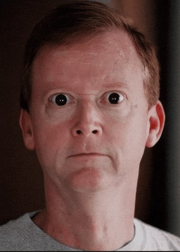A man with wide, surprised eyes and a grimacing expression stares directly at the camera, his face conveying a stunned or shocked reaction. The post humorously suggests that only two people were responsible for the unexpected shift from NFTs to memecoins in April 2023, with the man's exaggerated expression likely representing the disbelief many felt about the crypto market's sudden pivot.