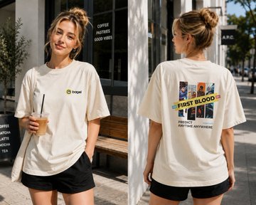Two views of a woman modeling a cream-colored t-shirt featuring a 'Jeep' logo on the front and a 'First Blood' movie poster design on the back with the tagline 'Somebody's gonna die tonight. Anytime, anywhere.'