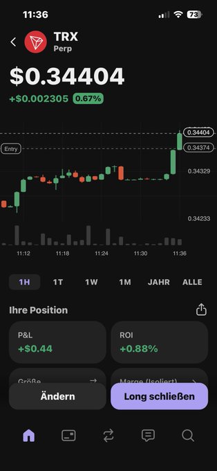 The image shows an iPhone screen with several app icons, including "TRX", which appears to be the primary focus of the viewer's attention. Below the TRX icon, there is a foreign language text displayed that reads: "Bin auch noch schnell auf den trx Zug". The image also contains some financial data and symbols like dollar and stock exchange graphs.