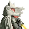 A small image of an action figure or character wearing gray armor and a white head wrap/bandage, holding what appears to be a yellow weapon.
