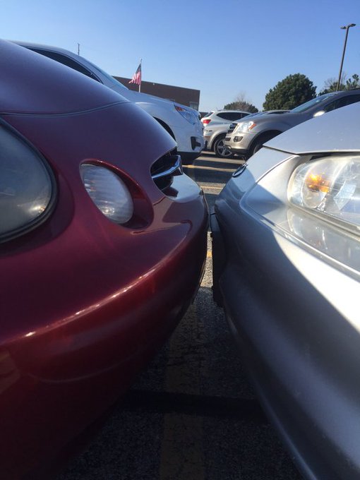 A close-up shows a red car parked tightly next to a silver car, with an American flag and other vehicles visible in a dealership lot under a clear blue sky. The cramped parking reflects the post's message about reaching 999,750 total transactions—just 250 away from a historic 1,000,000 milestone on the network.