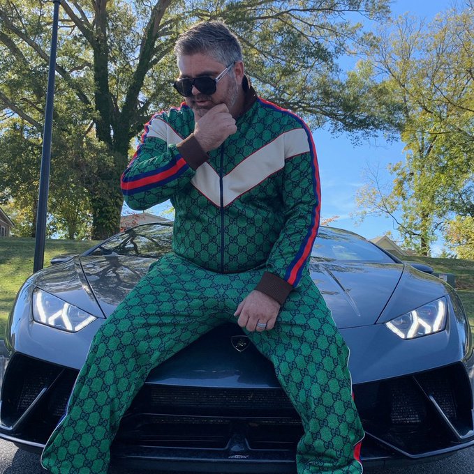 A man wearing a green Gucci tracksuit and sunglasses poses confidently on the hood of a sleek Lamborghini, exuding a flashy, status-driven aesthetic that aligns with the "Colethereum" post's vibe of luxury and crypto-influencer culture.