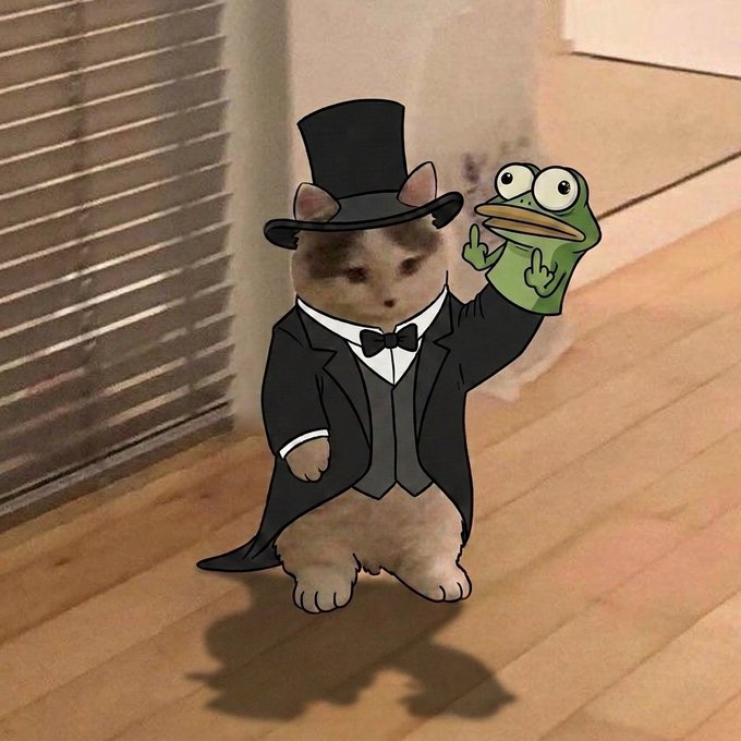 A digitally edited image of a small kitten wearing a black tuxedo, top hat, and bow tie, holding up a frog hand puppet.
