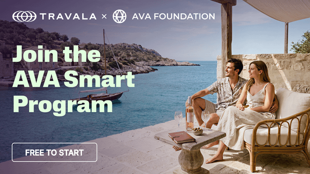 A promotional banner for the Travala x AVA Foundation 'AVASmart Program' shows a couple relaxing on a stone patio overlooking the Mediterranean, with a 'FREE TO START' button displayed.