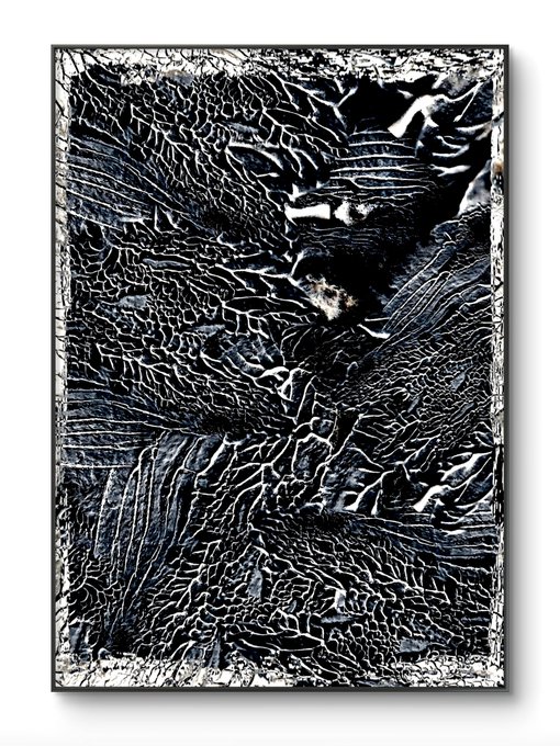 An abstract textured artwork in black, white, and gray featuring intricate crackled and web-like patterns that resemble weathered stone or veined marble in a black frame.