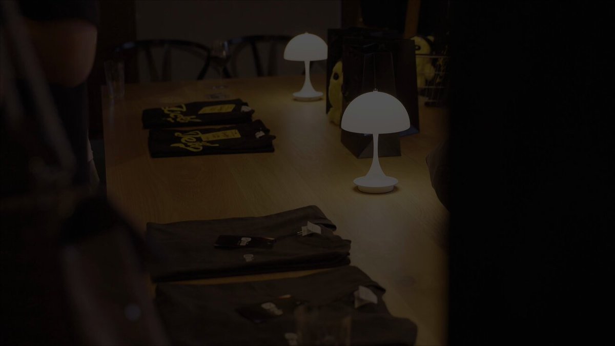 The image shows a group of people gathered around a dining table with lamps in front of them. The lamps are lit up, adding a warm ambiance to the scene. There are also two black bags placed near some clothing items, possibly waiting for their owners or participants in the gathering. In addition to these details, there's text on the image that reads: "Tokyo just met Tria Tria and @DecibelTrade gathered the Tokyo crypto community for a dinner last week. Builders, traders, and partners filled the room, talking about where onchain trading goes next. Japan is moving fast and the night proved it This is just the start".